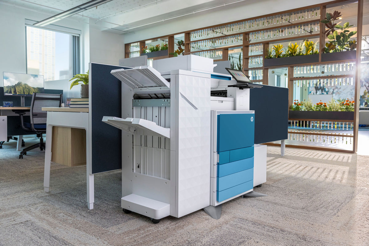 A LaserJet printer in a print room with shelving in the background